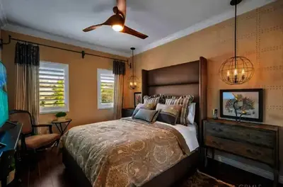 a bedroom with a large bed and a ceiling fan at Luxury Estate Tucked Away in the Exclusive Area of Tenaja in Murrieta
