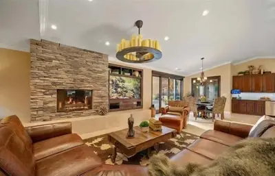 a living room with leather furniture and a fireplace at Luxury Estate Tucked Away in the Exclusive Area of Tenaja in Murrieta