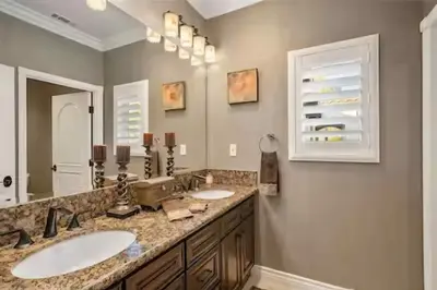 a bathroom with two sinks and a large mirror at Luxury Estate Tucked Away in the Exclusive Area of Tenaja in Murrieta