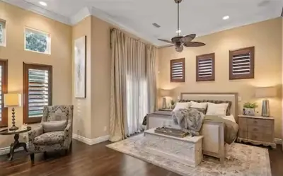 a bedroom with a bed and a chair at Luxury Estate Tucked Away in the Exclusive Area of Tenaja in Murrieta