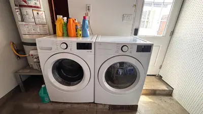 a washer and dryer in a laundry room at San Diego Oasis Fire Pit, Putting Green, Near Everything in San Diego