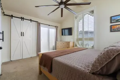 a bedroom with a bed and a ceiling fan at New Cozy Leucadia Beach House with parking in Encinitas
