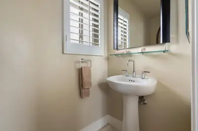a bathroom with a sink and a mirror at New Cozy Leucadia Beach House with parking in Encinitas