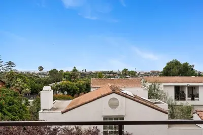 a view of a white house with a roof at New Cozy Leucadia Beach House with parking in Encinitas