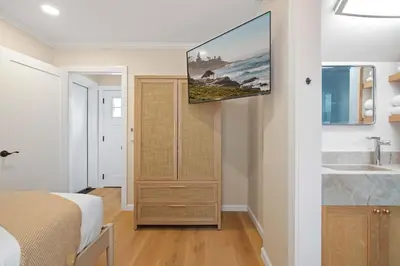a bedroom with a tv hanging on the wall at Renovated Coastal 2BR - Stylish & Bright in San Diego
