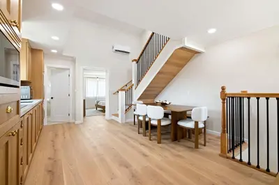 a kitchen and dining room with a table and chairs at Renovated Coastal 2BR - Stylish & Bright in San Diego