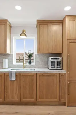 a kitchen with wooden cabinets and a microwave at Renovated Coastal 2BR - Stylish & Bright in San Diego