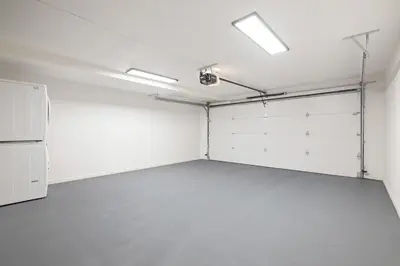an empty garage with white walls and a refrigerator at Renovated Coastal 2BR - Stylish & Bright in San Diego