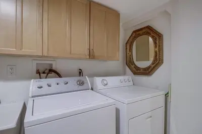 a kitchen with white appliances and a mirror at 3BRB with Bonus Bedroom, Hot Tub, Tropical Oasis in San Diego