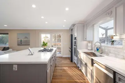 a kitchen with white cabinets and a large island at Luxury Home OceanView in San Diego