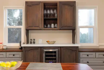 a kitchen with wooden cabinets and a counter with a table at Luxury Home OceanView in San Diego