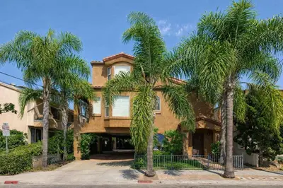 a house with palm trees in front of it at Prime Location Spacious townhome in San Diego