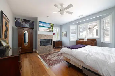 a bedroom with a bed and a fireplace at Prime Location Spacious townhome in San Diego