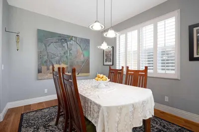 a dining room with a white table and chairs at Prime Location Spacious townhome in San Diego