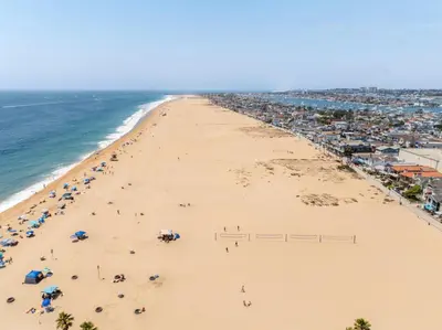 an overhead view of a beach with people and umbrellas at Sail & Sea in Newport Beach