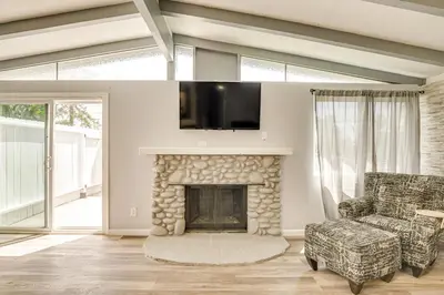 a living room with a fireplace and a tv at 6 Mi to Pacific Beach Pet-Friendly San Diego Home in San Diego