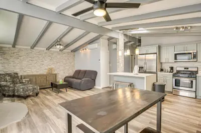 a large living room with a table and a kitchen at 6 Mi to Pacific Beach Pet-Friendly San Diego Home in San Diego