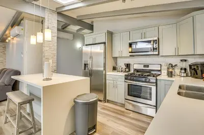 a kitchen with white cabinets and a counter top at 6 Mi to Pacific Beach Pet-Friendly San Diego Home in San Diego