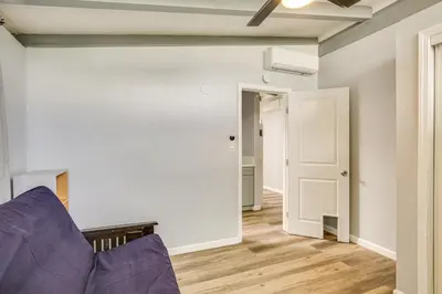 a living room with a purple couch and an open door at 6 Mi to Pacific Beach Pet-Friendly San Diego Home in San Diego