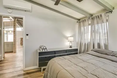 a bedroom with a bed and a desk with a lamp at 6 Mi to Pacific Beach Pet-Friendly San Diego Home in San Diego