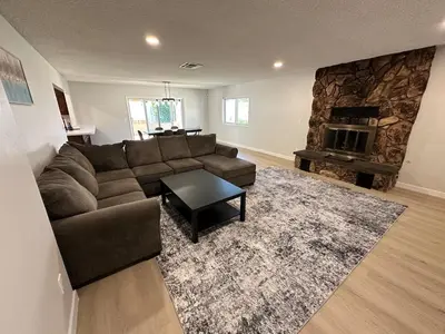 a living room with a couch and a fireplace at Family Fun Getaway - 3BR - Games - BBQ Patio in Santee