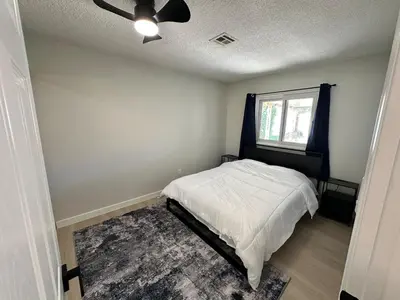 a bedroom with a bed and a ceiling fan at Family Fun Getaway - 3BR - Games - BBQ Patio in Santee