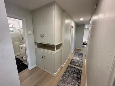 a bathroom with white cabinets and a toilet at Family Fun Getaway - 3BR - Games - BBQ Patio in Santee
