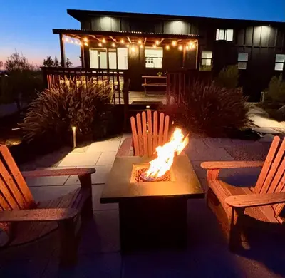 a fire pit in front of a house with two chairs at The Hilltop Haven - Romantic Getaway Suite in Temecula