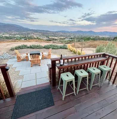 a deck with chairs and a table with a view at The Hilltop Haven - Romantic Getaway Suite in Temecula