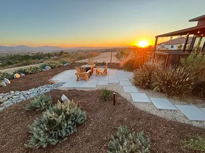 a patio with a picnic table and the sunset at The Hilltop Haven - Romantic Getaway Suite in Temecula