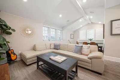 a living room with a couch and a table at Steps from Bay Ocean Villa in San Diego