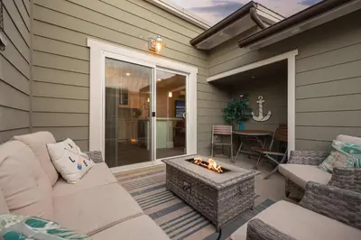 a patio with a couch and a fire pit at Steps from Bay Ocean Villa in San Diego