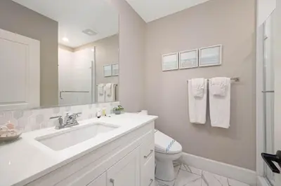 a white bathroom with a sink and a toilet at Steps from Bay Ocean Villa in San Diego