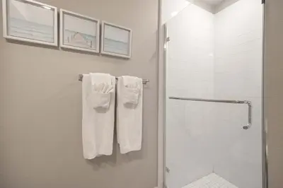 a bathroom with a shower and white towels at Steps from Bay Ocean Villa in San Diego
