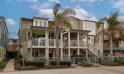a large house with palm trees in front of it at Steps from Bay Ocean Villa in San Diego