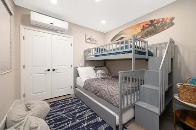 a small room with a bunk bed and a staircase at Steps from Bay Ocean Villa in San Diego