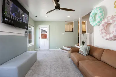 a living room with a couch and a flat screen tv at Cozy Chic Casa ,Spa ,Ac ,Theatre , Downtown, Beach in La Mesa