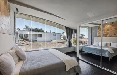a bedroom with a bed and a large window at The Wave House! Custom Gem with Panoramic Views, Fire Pit, BBQ, Pool Table in San Diego