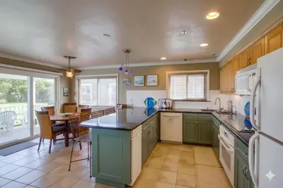 a kitchen with green and white appliances and a table at Bayside Gem - Beachfront - Vibrant - Ocean Breeze in San Diego