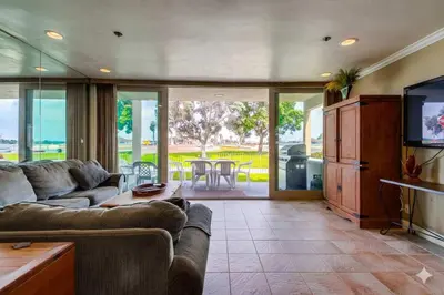 a living room with a couch and a flat screen tv at Bayside Gem - Beachfront - Vibrant - Ocean Breeze in San Diego