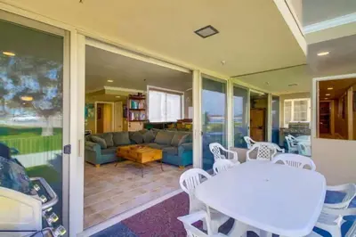 a living room with a table and a couch at Bayside Gem - Beachfront - Vibrant - Ocean Breeze in San Diego
