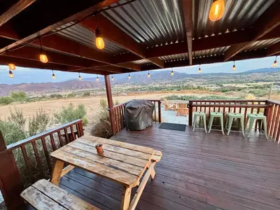 a wooden deck with a table and chairs on it at The Hilltop Haven - Private View Suite in Temecula