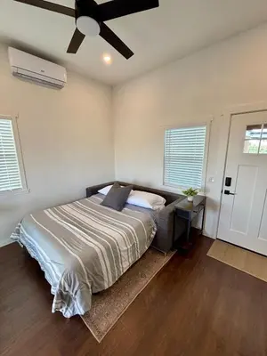 a bedroom with a bed and a ceiling fan at The Hilltop Haven - Private View Suite in Temecula