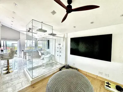 a living room with a ceiling fan and a tv at Vintoca Luxury Honeymoon Suite Farm Retreat in Oceanside