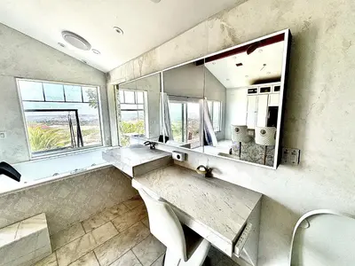 a bathroom with a sink and a large mirror at Vintoca Luxury Honeymoon Suite Farm Retreat in Oceanside