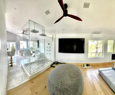 a living room with a ceiling fan and a couch at Vintoca Luxury Honeymoon Suite Farm Retreat in Oceanside