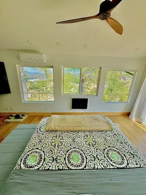 a bedroom with a large bed with a ceiling fan at Vintoca Luxury Honeymoon Suite Farm Retreat in Oceanside