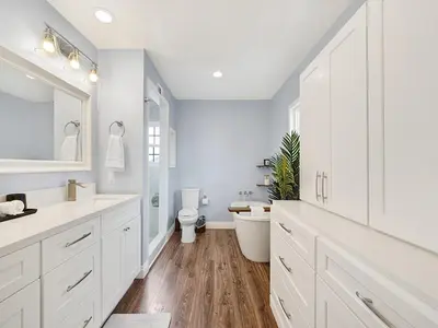 a white bathroom with a toilet and a sink at OC Heated Pool,Fire Pit,Spa,BBQ,Disney,Beaches in Mission Viejo