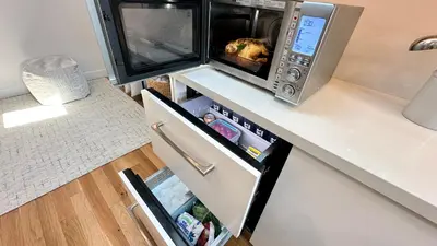 a microwave oven sitting on top of a refrigerator at Bay View Bungalow in San Diego