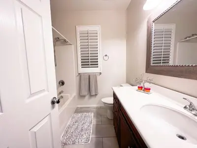 a bathroom with a sink and a toilet and a mirror at \u6a59\u53bf\u6e29\u99a8\u8212\u9002\u6c11\u5bbf in Irvine